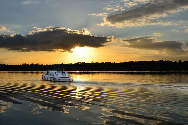 A Boat on Barton Broad at Sunset